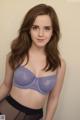 A woman in a purple bra and black panties posing for a picture.